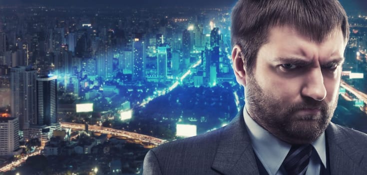 Morose businessman against night city