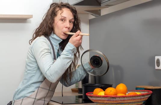 a young woman with long hair is in the kitchen