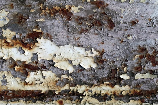 Rusty iron surface with cracks and peeling paint - texture