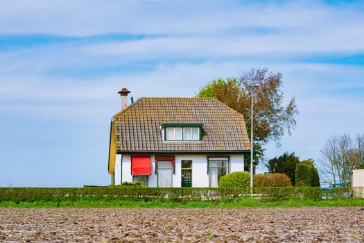 Small house near the plowed field in the Netherlands