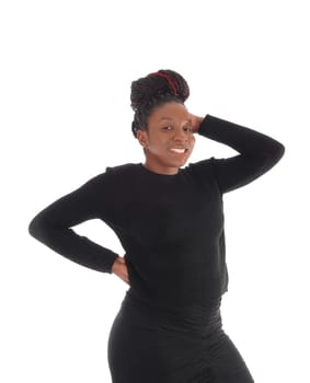 Beautiful African America woman standing in a black dress with one.hand behind her head, isolated for white background.