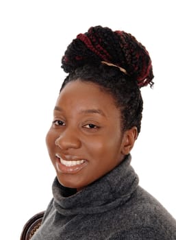 A close up image of an African American woman with her curly hair.as a bun on her head, smiling, isolated for white background.