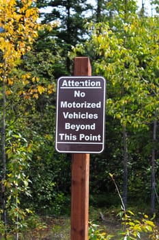 An attention no motorized vehciles beyond this point sign.