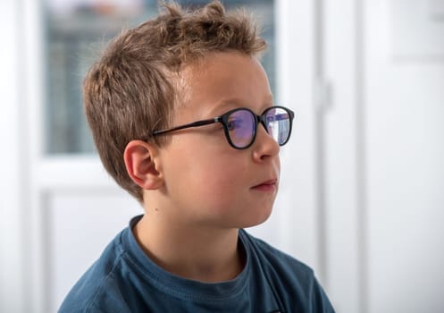 a portrait of a boy with glasses