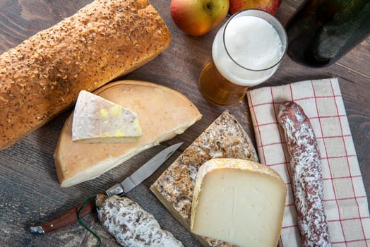 cheeses and Tomme de Savoie with beer, French cheese Savoy, the french Alps France.