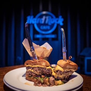 Los Angeles - september 5, 2019. Hamburger on table with Hard Rock Cafe logo in background