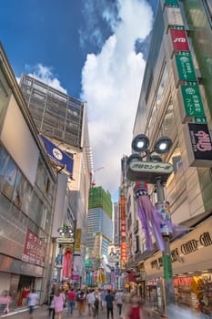 Summer blue sky on Shibuya Center Gai Street which literally means Shibuya Central District. The busiest street once intersected with Shibuya Station, it stretches for 350 meters and incorporates the adjacent streets of Bunkamura, Inokashira and Utagawa into its neighborhood. In 2011 the street was renamed Basketball Street in reference to the holy place of Japanese basketball which is the Yoyogi National Gymnasium to which this street leads. The photo is taken in summer at the Tanabata Star Festival where the portal is adorned with paper decorations in the shape of shooting stars for the occasion.