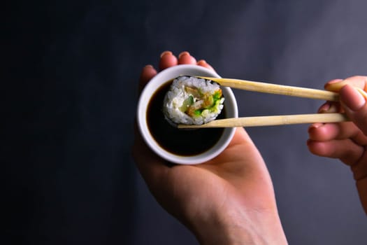 Top view of wooden platter with great set of delicious Nigiri sushi and Tempura rolls with Maki and Uramaki rolls on an rad background. Top views