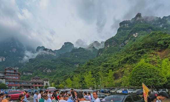 Zhangjiajie, China -  August 2019 : Massive tourist crowds in a extremely long queue to the Tianmen Mountain entrance of the Zhangjiajie National Park, Hunan Province