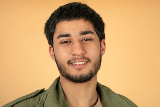Beautiful black haired man on beige background