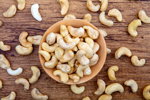 Cashew Nuts in wooden Bowl on brown background