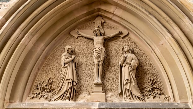 Christian church portal in detail of St. Laurentius church in Saarburg