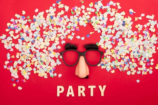 Funny mask surround colorful confetti on red background