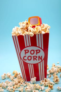 Crunchy Popcorn with Toy TVon bright blue background