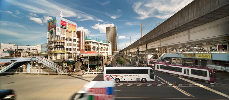Oji station JR Keihin Tohoku Line in the Kita district, north of Tokyo. The pedestrian walkway spans the intersection of Meiji Avenue where the Ojiekimae station of the Toden Arakawa tram line is famous for its retro style.