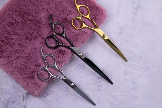 Set of cosmetic tools for manicure and pedicure on an orange background. Nearby there is an open notebook for writing, gel varnishes, a mill, nail files, scissors and nippers. Top views with clear space