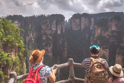 Zhangjiajie, China - August 2019 : Tourists admiring the view on the Bridge Heaven Pillar viewpoint, Avatar mountains nature park