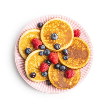 Sweet homemade pancakes with blueberries and raspberries isolated on white background.
