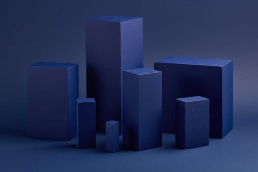 Abstract composition with geometric figures. Set of rectangular parallelepipedes on a blue background. Abstract background with copy space for design of advertising, engineering draft, web design.