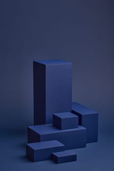 Abstract composition with geometric figures. Set of rectangular parallelepipedes on a blue background. Abstract background with copy space for design of advertising, engineering draft, web design.