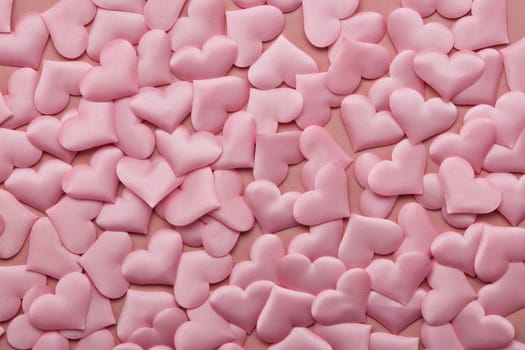 Valentine background from pink silk hearts. Valentine's Day card. Top view with copy space. Design element for romantic greeting card, invitation. Women's Day. Hearts background. Wedding day.