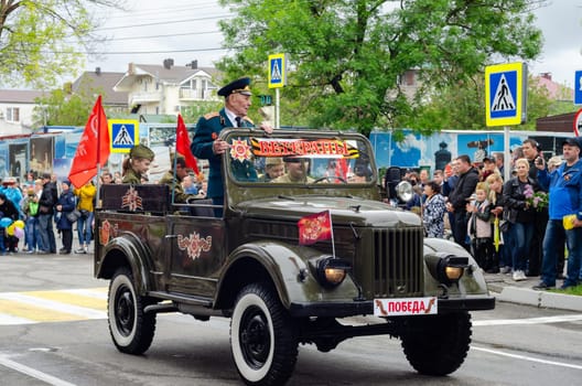 Anapa, Russia - May 9, 2019: Veterans ride the streets of the city of Anapa in an old restored military vehicle