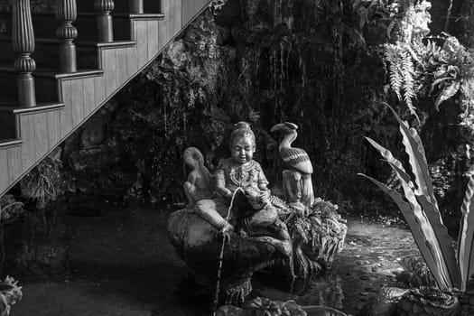 fountain baby statue water nature indoors black white