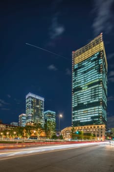 Night view of KITTE commercial facility building deployed by Japan Post in 2013, The GranTokyo and Pacific Century Place Marunouchi skyscrapers overlooking the railroad tracks of Tokyo Station. The GranTokyo building, whose first 14 storeys are occupied by the Daimaru department store, is 205 meters high and was inaugurated in 2007. The Pacific Century Place building is 150 meters and 32 storeys high and was inaugurated in 2001.