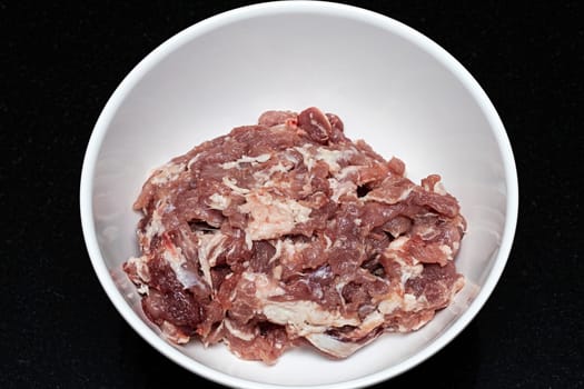 minced pork meat white bowl black background raw