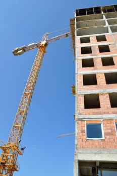 Apartment building constructions, with big crane in motion