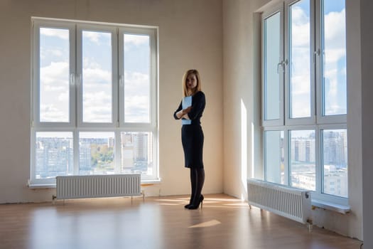 Realtor expects buyers in a large room with huge windows