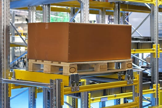 Cardboard box and pallet at warehouse shelf