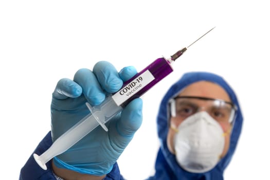 Doctor in protective mask and gloves holding syringe with virus COVID 19 vaccine.