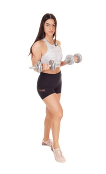 A beautiful young woman in exercising outfits standing in the studio.working out with her two dumbbells, isolated for white background.