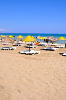 Handmade palm leaf and cane umbrellas on a beautiful Cyprus beach