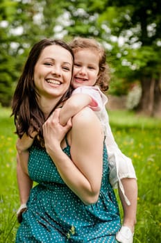 Small girl enjoying life with her mother outdoor - lifestyle portrait