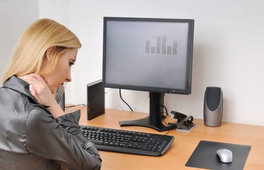 Business woman with neck pain on workplace