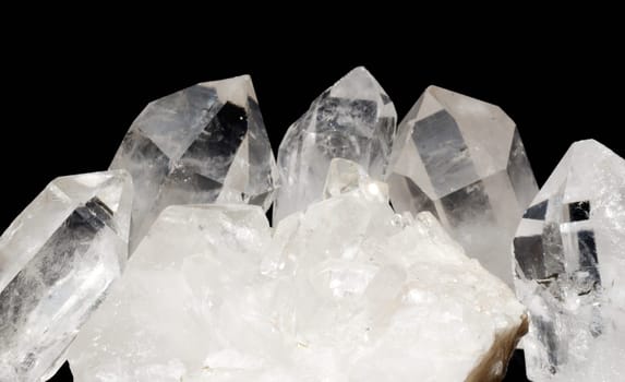Druze of quartz crystals with quarts crystals laid on black textile. Druzes are used in esoteric for energizing other gems and also in alternative medicine.