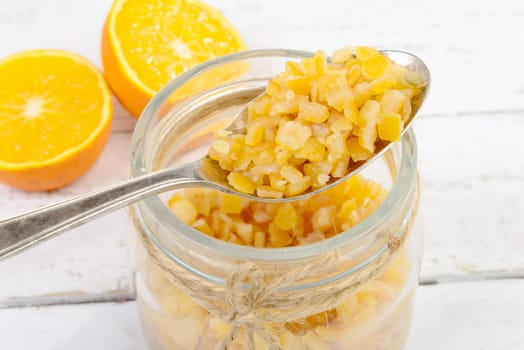 candied oranges cut into pieces on the white wooden table