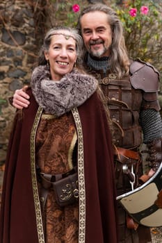 Couple posing robed in beautiful medieval clothing