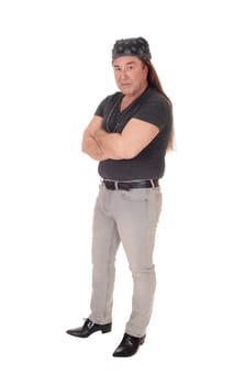 A serious looking middle age man in a black sweater standing with his .arms crossed and head scarf on his head, isolated for white background.