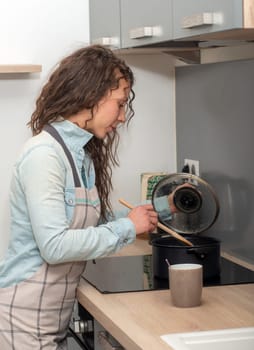 a young woman with long hair is in the kitchen