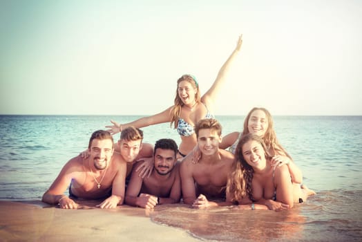 Group of happy young people at the beach