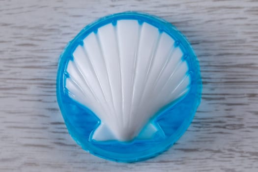 Glycerin base soap handmade with a white shell on a blue transparent base lying on the table