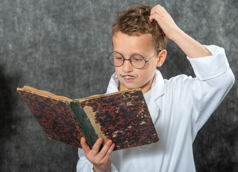 cheerful boy retro with a white blouse reading a book
