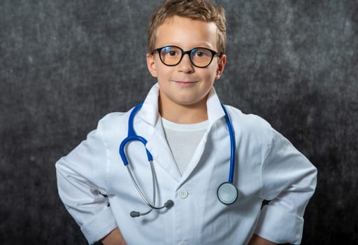 Cute kid boy wear medical uniform playing doctor, a portrait