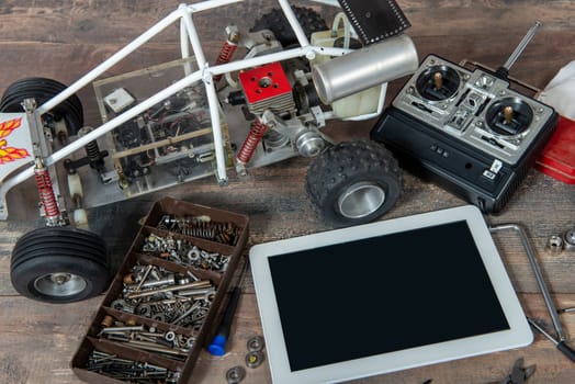 computer tablet with rc radio control car and tools