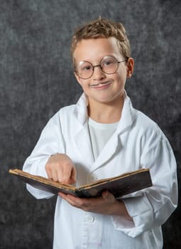 cheerful boy retro with a white blouse reading a book