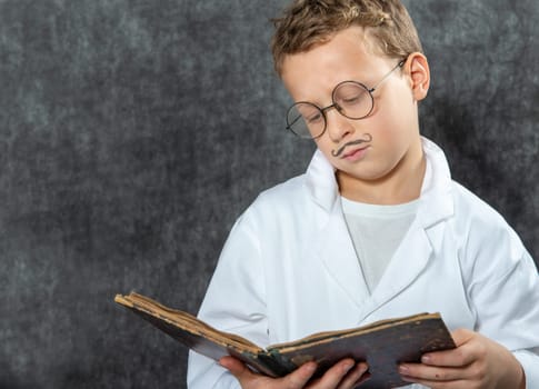 cheerful boy retro with a white blouse reading a book