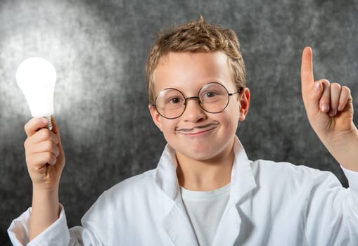 cute smiling child boy with a light bulb